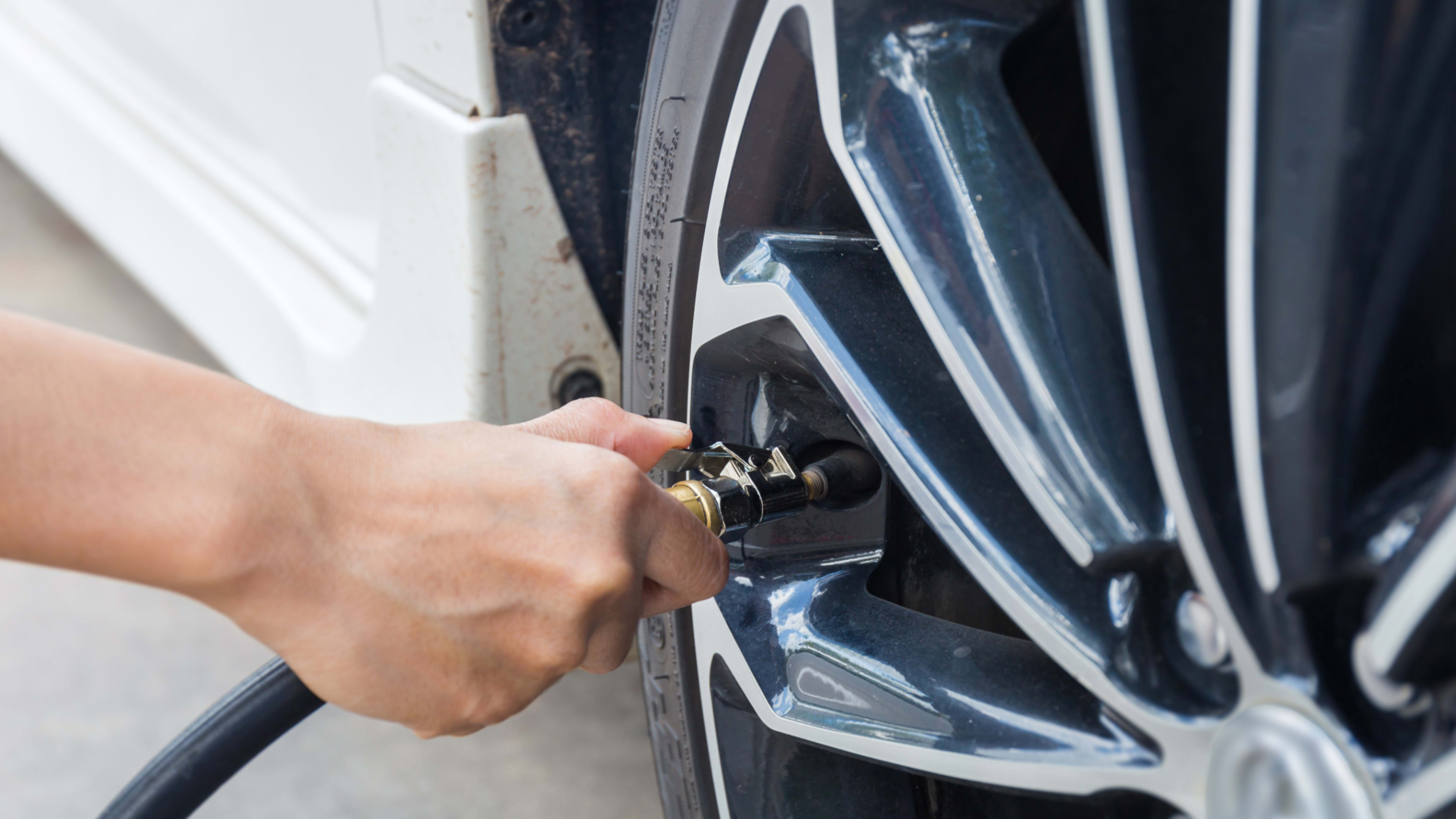person putting air in tires 