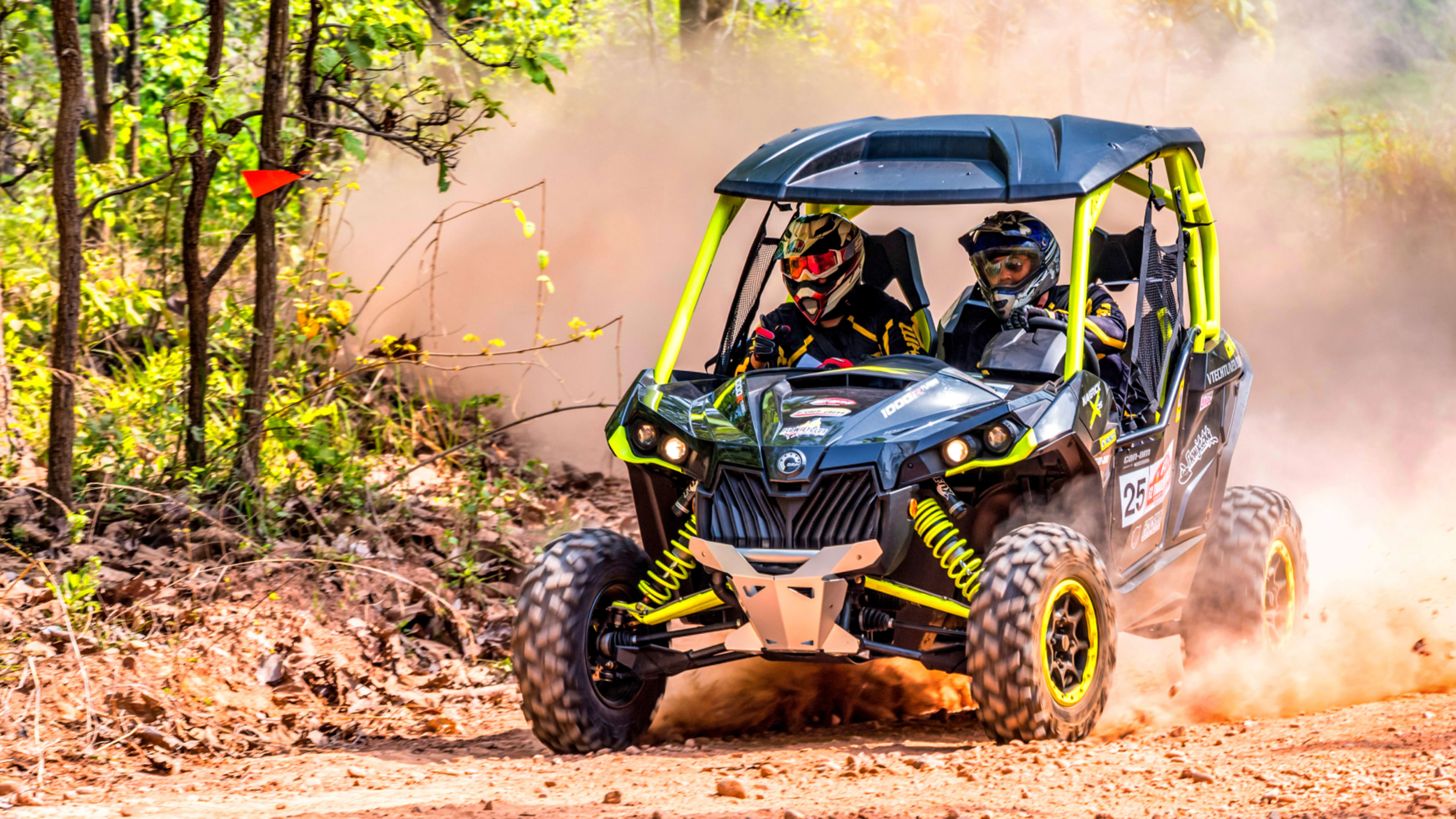 An All Terrain Vehicle Driving on a Wooded Trail