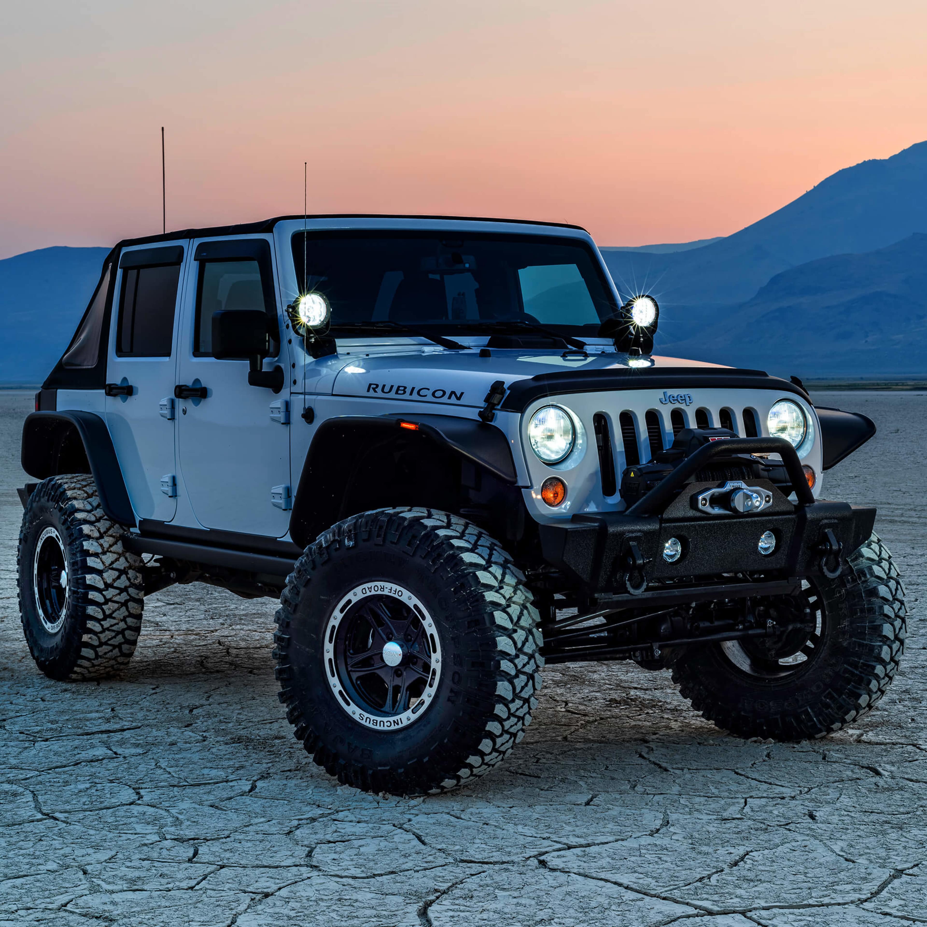 Mud terrain tires on a grey Jeep Wrangler