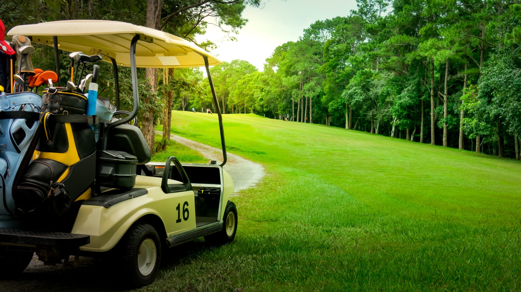 A Golf Cart Parked on a Lucious Green Course