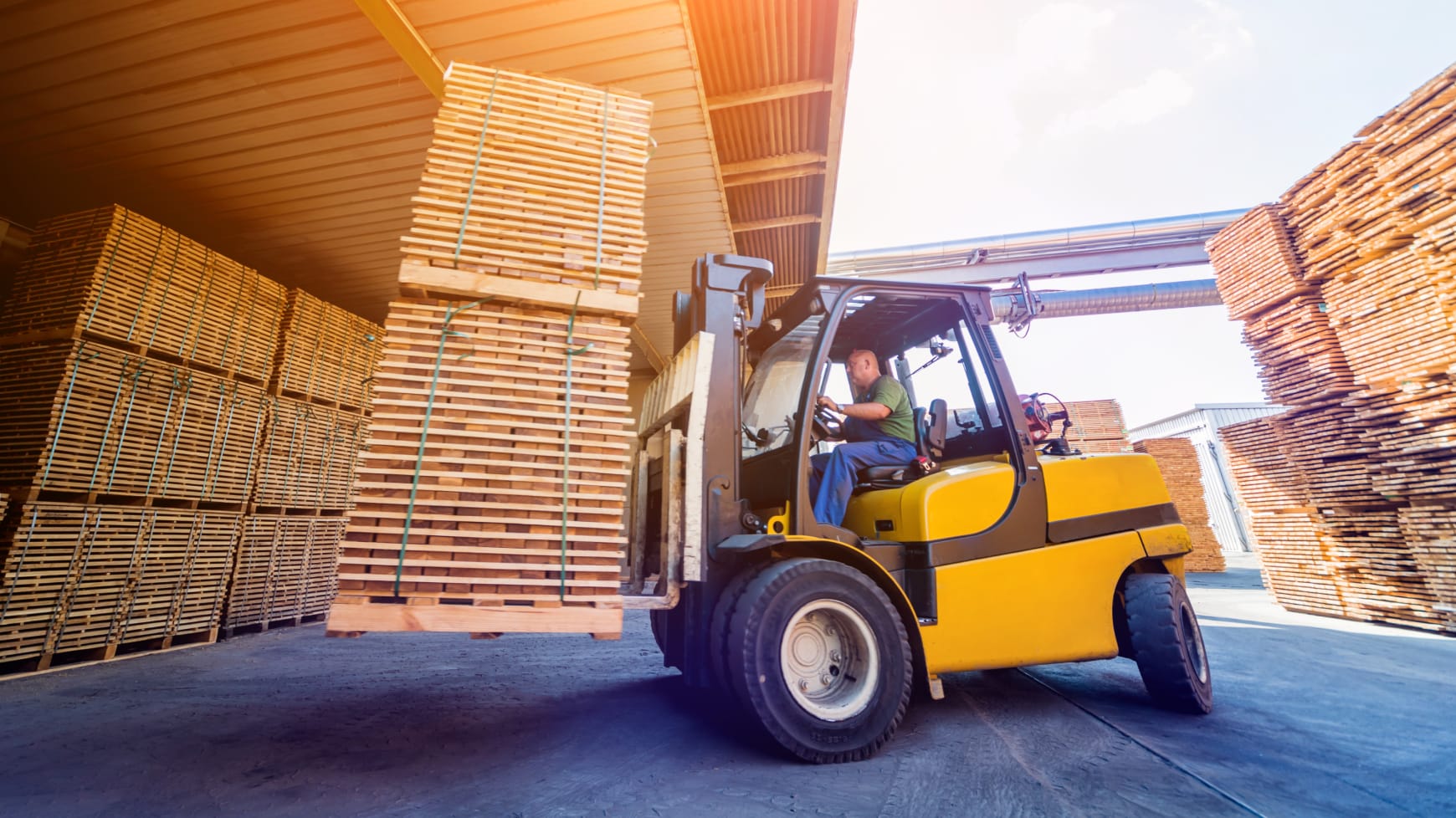 A Forklift Driving and Stacking Pallets in a Warehouse