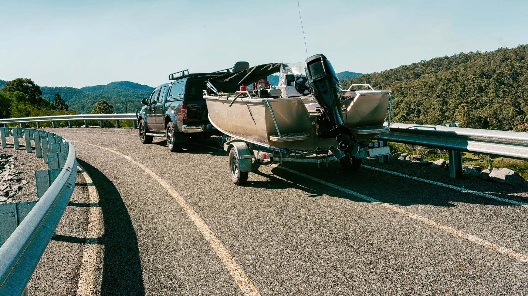 A Pickup Truck Towing a Boat on a Trailer