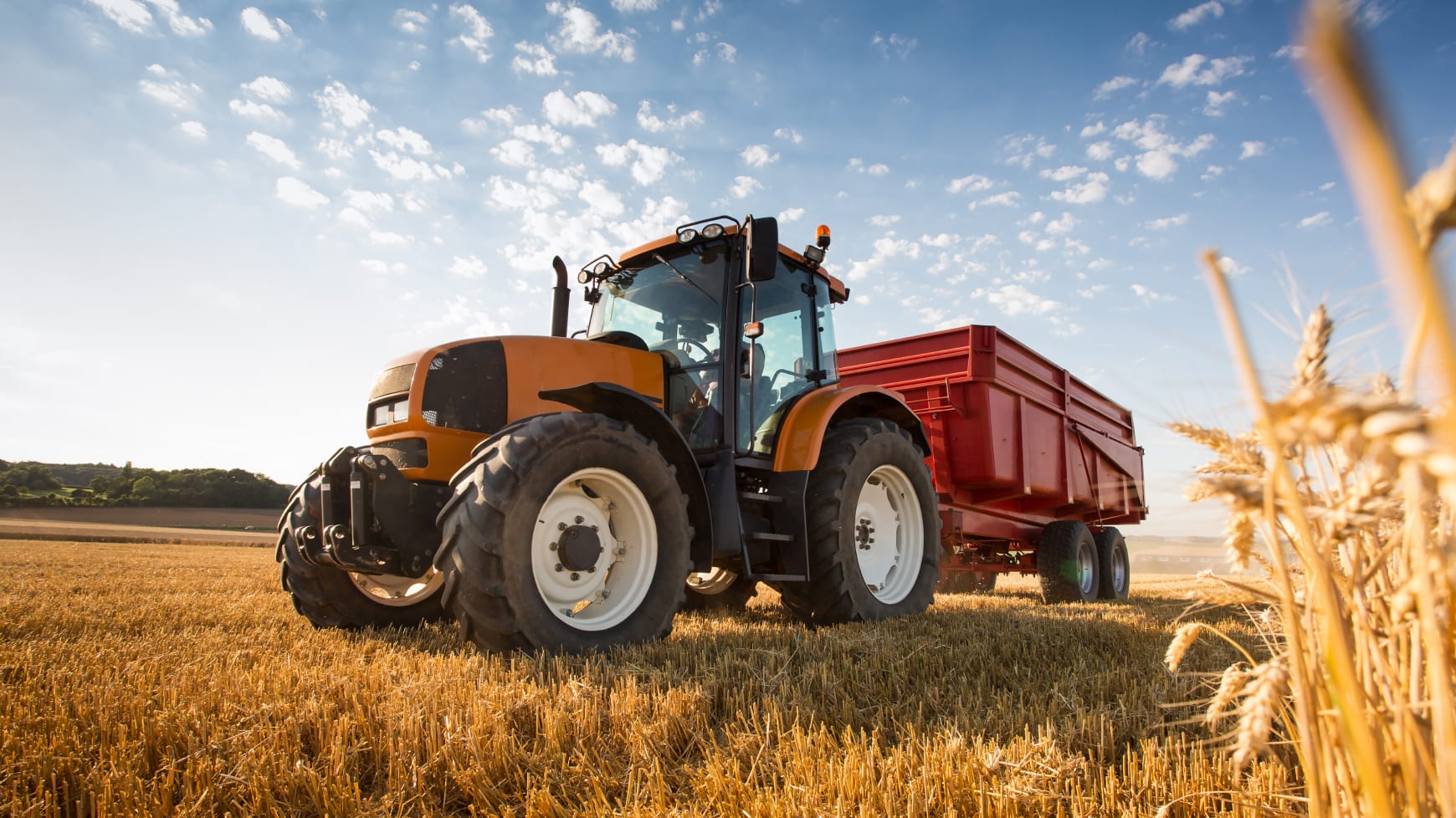 Farming Tractor Driving Through Crops