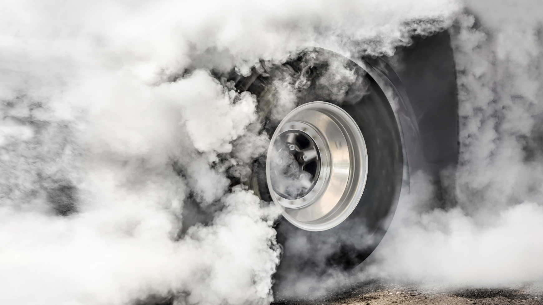 A Drag Racer Doing a Burnout on the Track