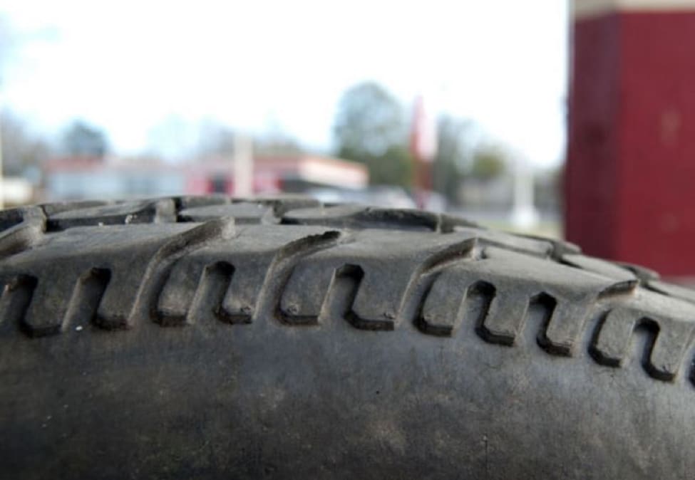 A sidewall closeup of heel toe wear of a tire.