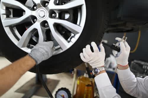 Professional mechanic checking a tire