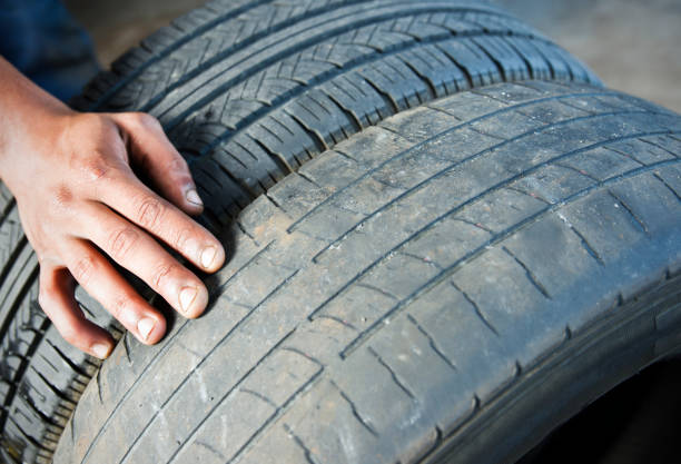 Man pointing to wear on tires