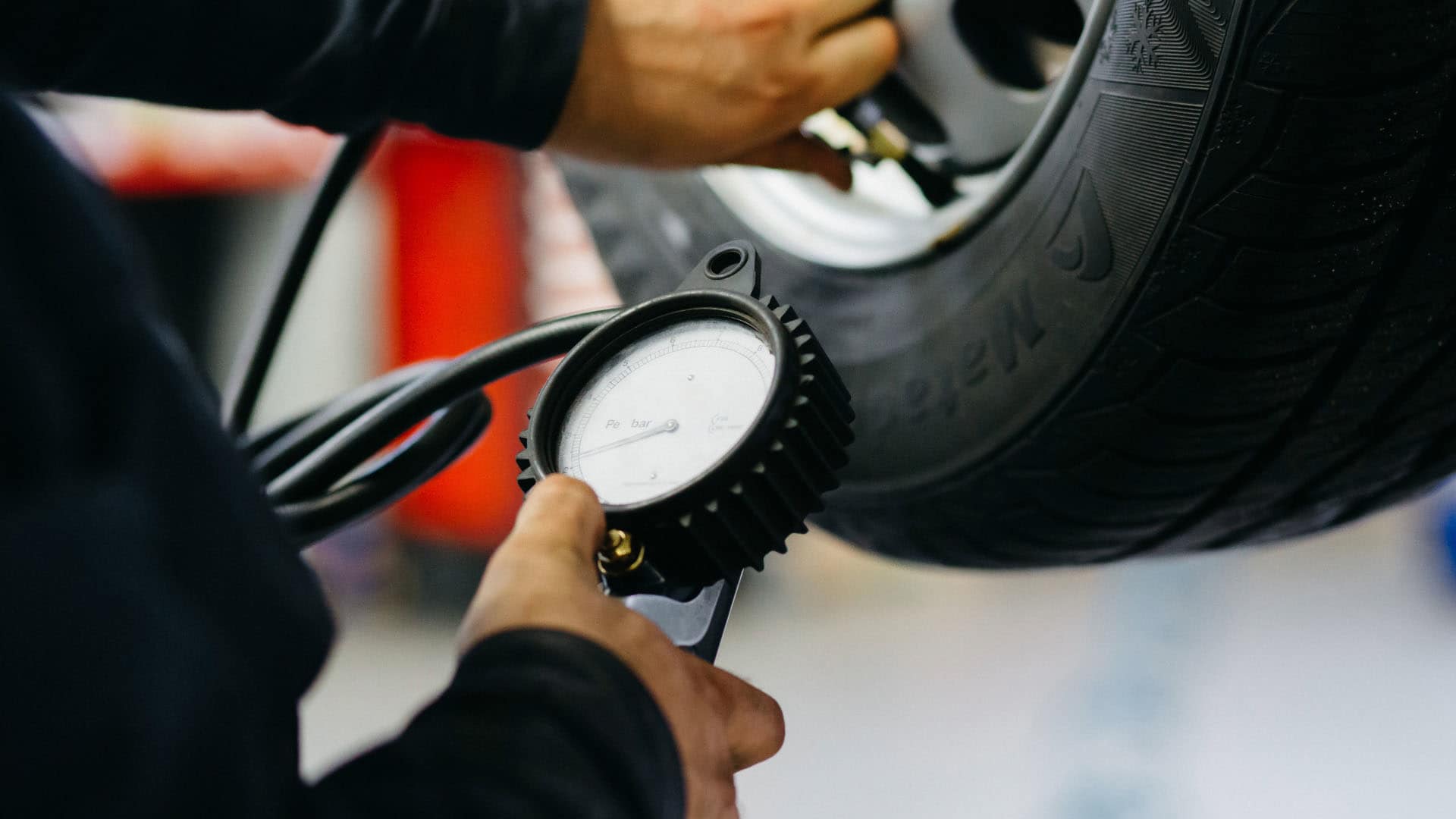 Mechanic checking tire pressure